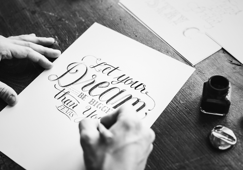 Closeup of a calligrapher working on a project